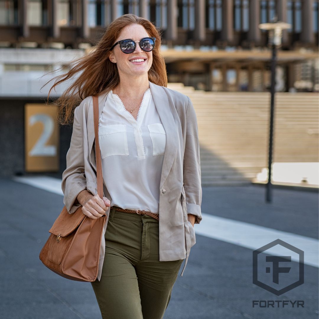 Confident woman walking a city on a bright day