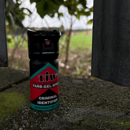 Image of a can of Farb-Gel criminal identifier spray standing on a wall in a park.